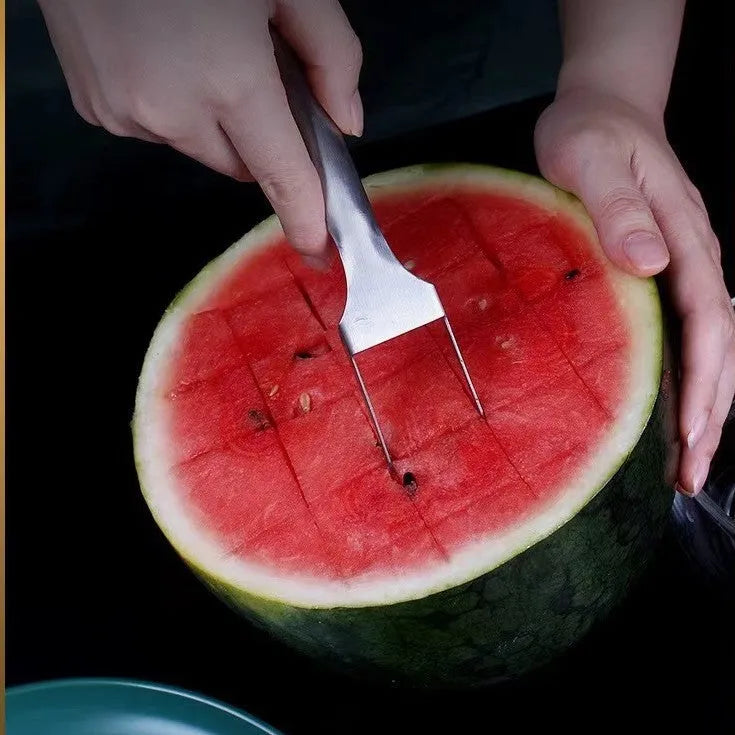 Stainless steel watermelon slicer and fork tool on a kitchen surface