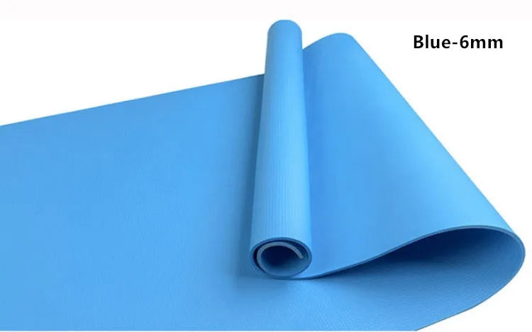 Red EVA fitness yoga mat rolled up next to its storage bag, showing textured surface.