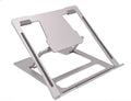 Foldable silver aluminium laptop stand with silicone grips on a desk, showing adjustable angle