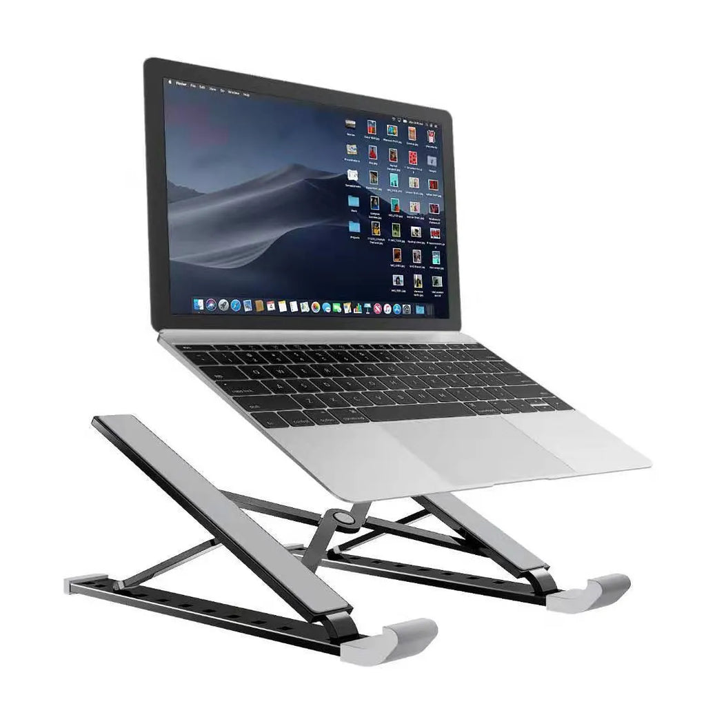 Silver adjustable folding laptop stand with hollow bottom and non-slip pads on a desk