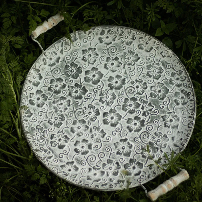 Round wrought iron storage tray in two sizes for organising jewellery or food on a countertop.