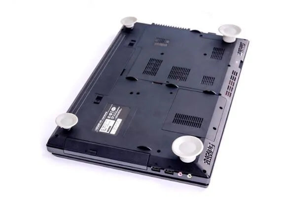 Set of four grey plastic non-slip cooling pads for laptops, two large and two small.