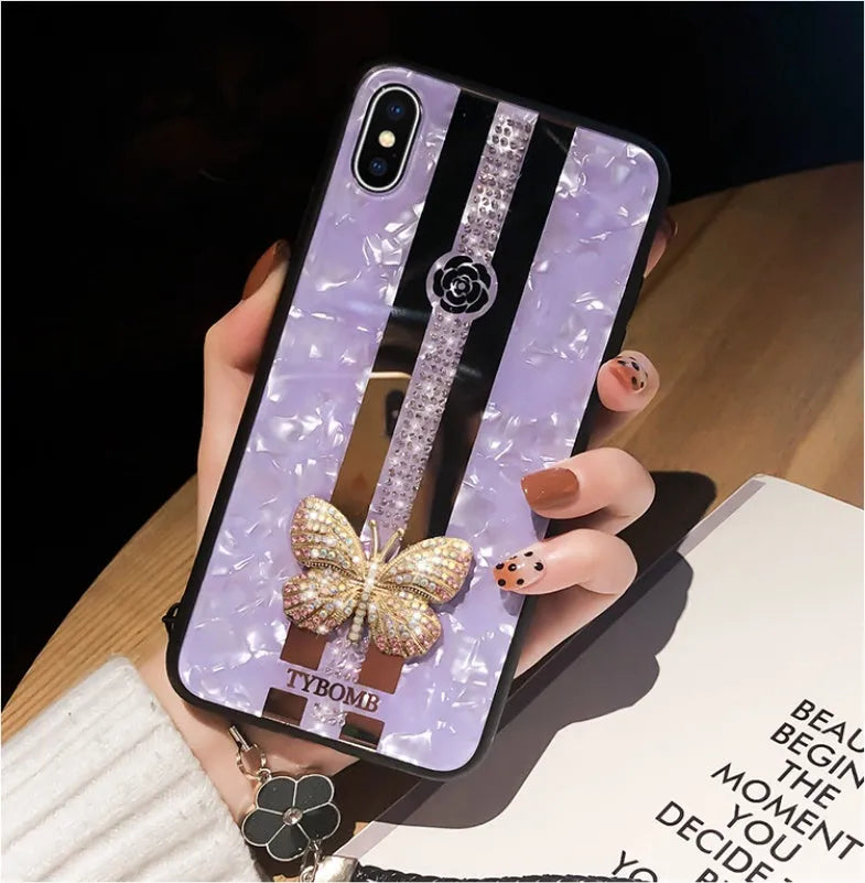 Luxury acrylic iPhone case with butterfly and diamond crystal design and a mirrored back in purple colour.