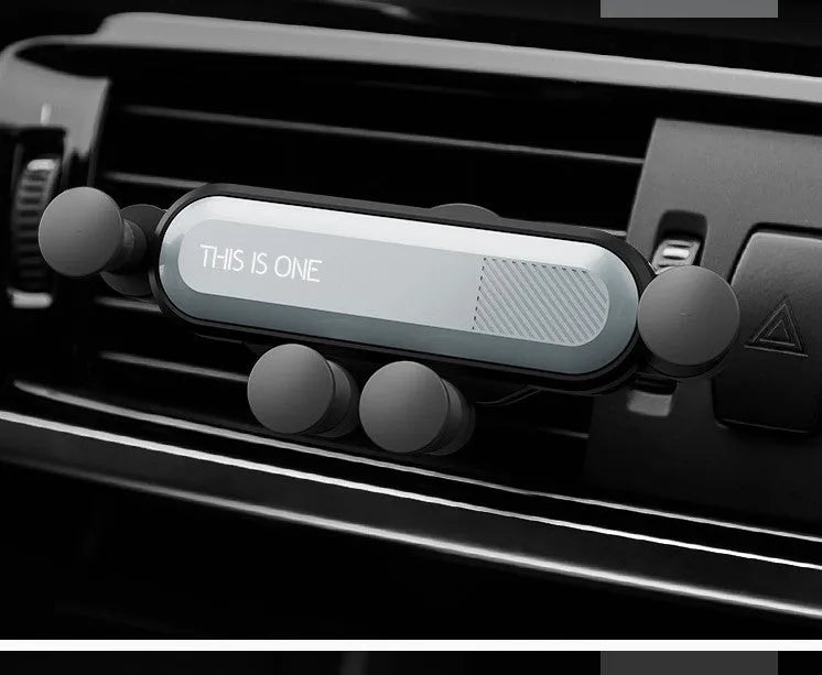 Universal black plastic car phone holder clipped onto a vehicle air vent