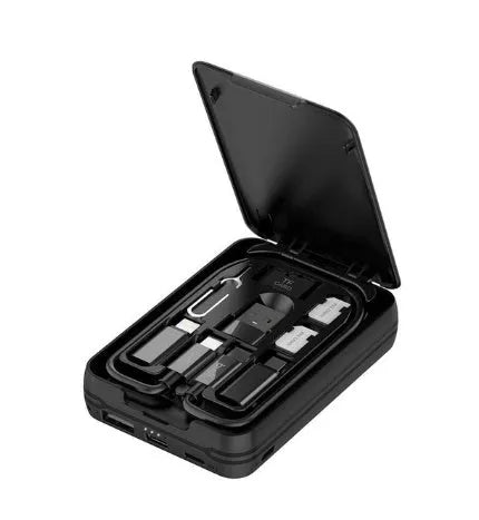 Black budi multi-functional power bank with cables and SIM kit on a table