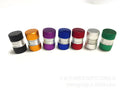 Seven aluminium alloy tyre valve dust caps in black, blue, gold, green, purple, red, and silver on a white background.