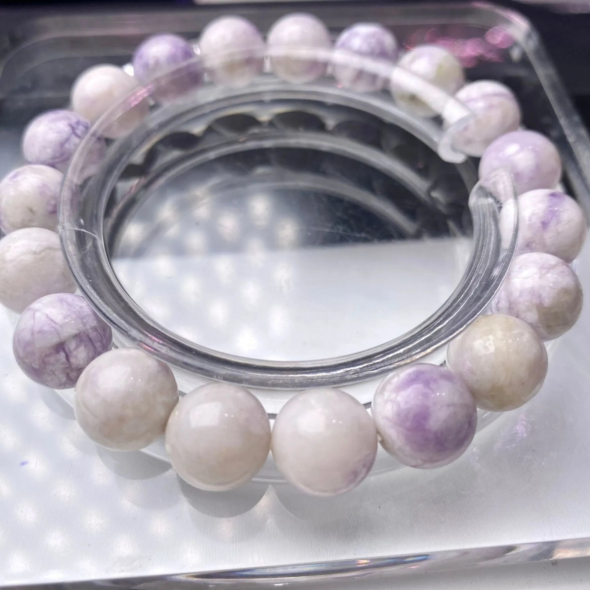 Close-up of a women's bracelet with natural purple turquoise beads on a wrist.