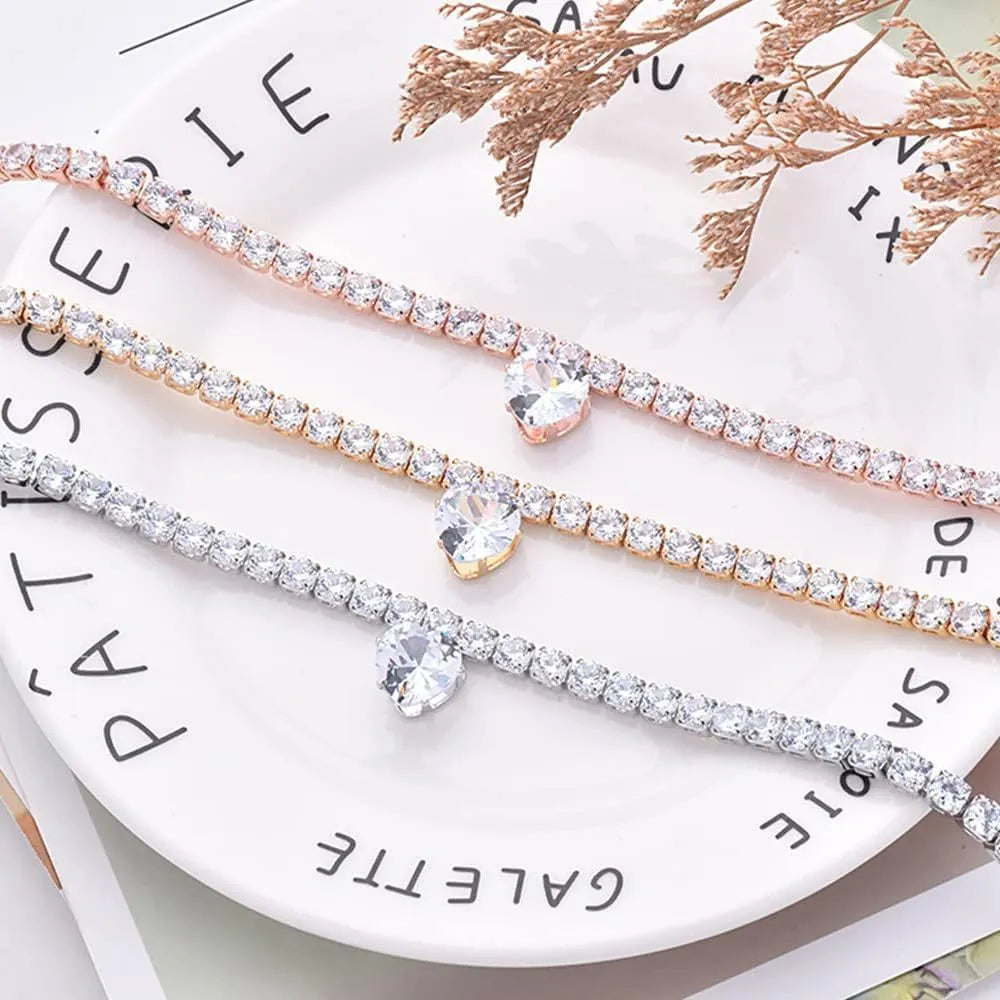 Shiny rhinestone heart-shaped collar for dog or cat in gold, on a size chart showing S, M, L measurements.