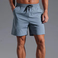 Men's loose-fit casual shorts in quick-dry polyester, shown in black, blue, khaki, or purplish red.