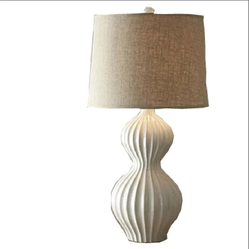 Jingdezhen ceramic table lamp with white fabric shade on wooden table