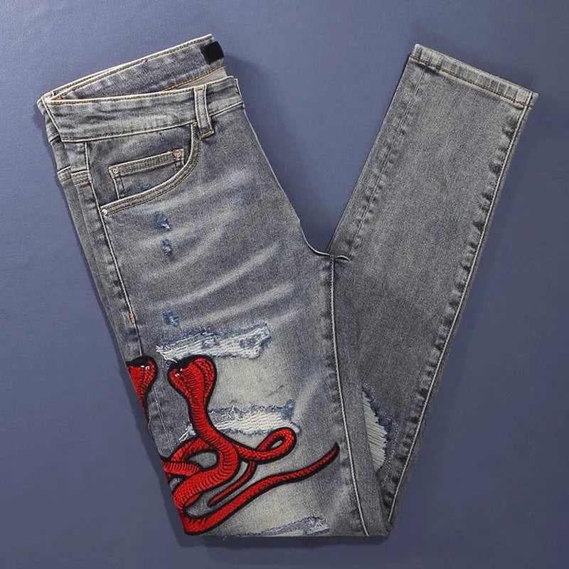 Men's slim fit jeans with embroidered patches and worn wash effect in old colour