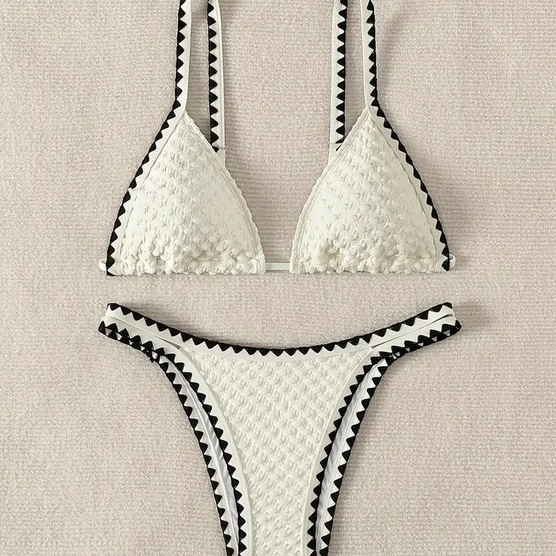 Women's blue and white polyester bikini swimsuit set with briefs style on hanger.