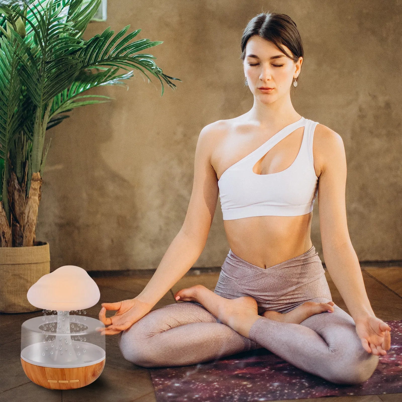 White cloud-shaped aromatherapy humidifier with colour-changing night light on a table.