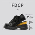 Black platform leather-style shoes with round toe and low top for height increase.