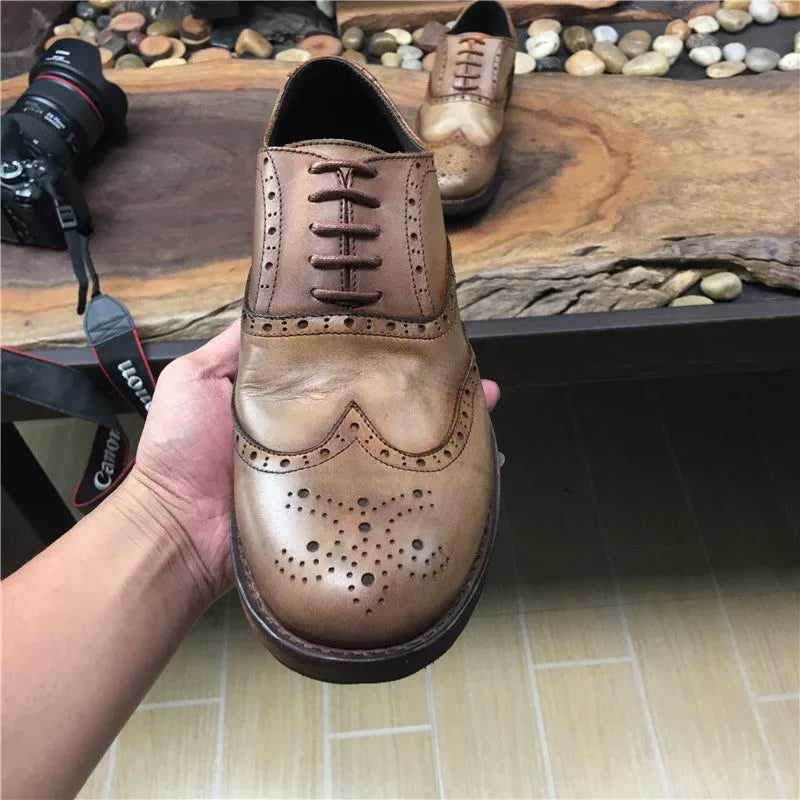 Men's light brown distressed leather lace-up shoes with engraved carving details on the upper.