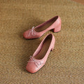 Women's round toe mid heel chunky leather pumps in solid colour with bow detail
