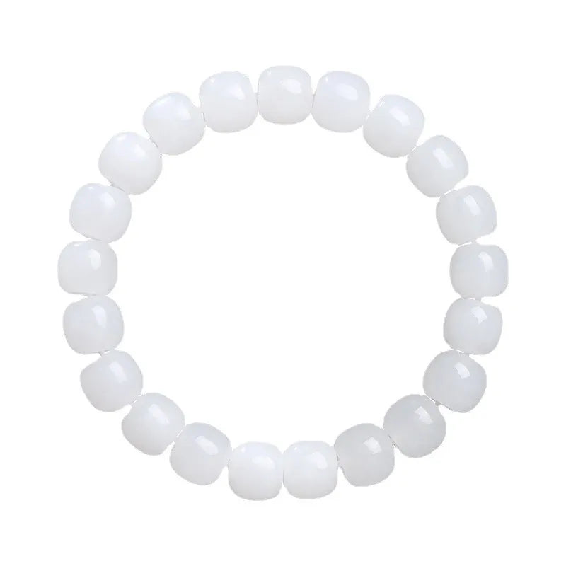 White Hetian jade barrel bead bracelet for men and women on a wooden surface.