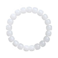 White Hetian jade barrel bead bracelet for men and women on a wooden surface.