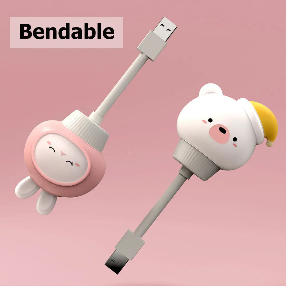 Cute cartoon animal USB night light in bear shape with soft white glow on a bedside table.