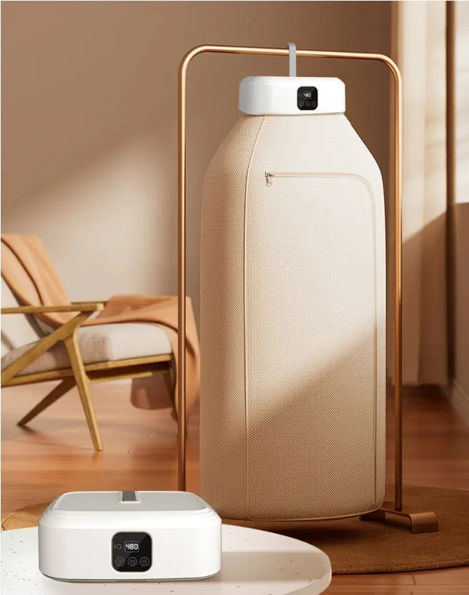 White cylindrical portable clothes dryer with remote control folded for storage