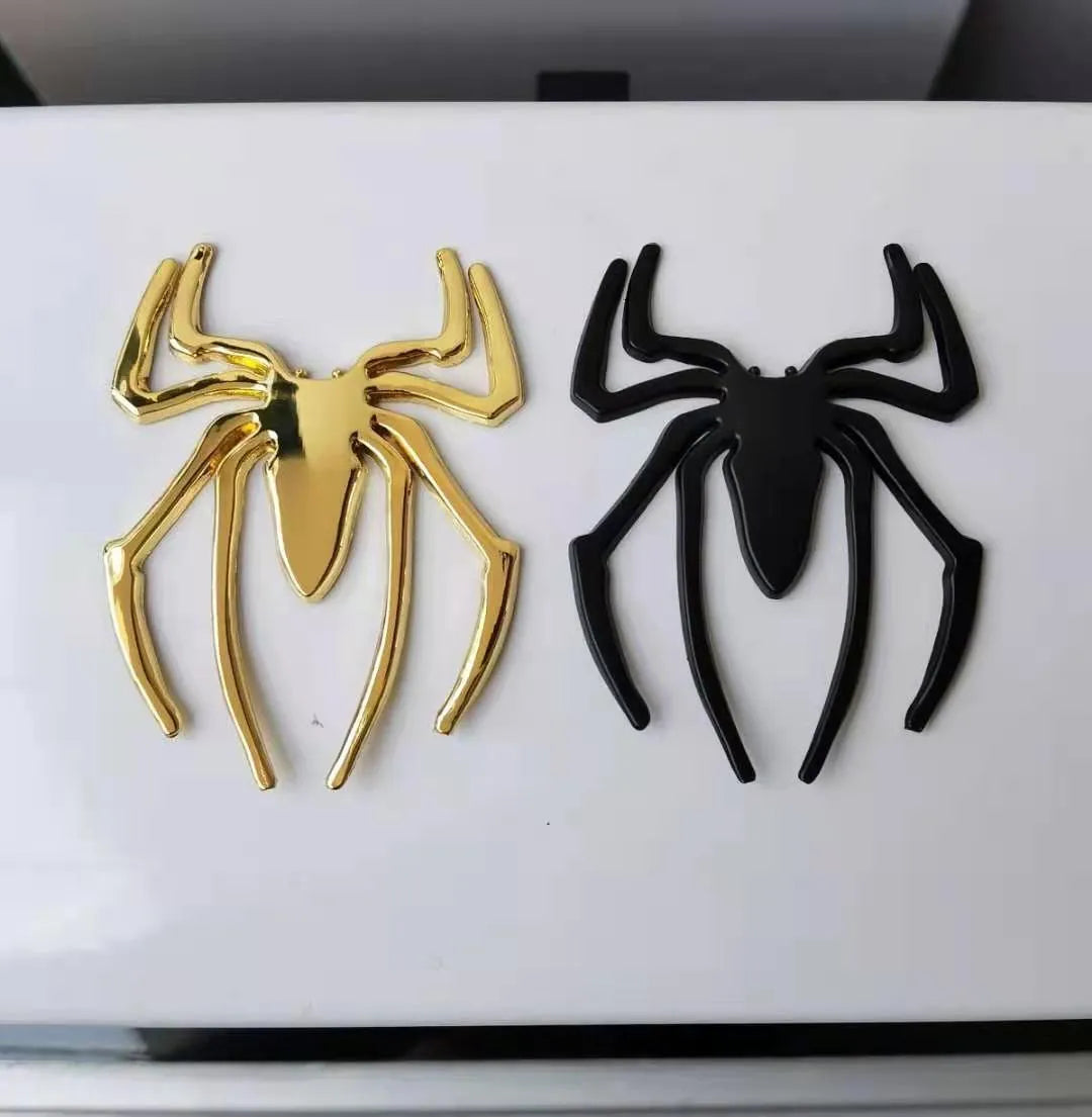 Three-dimensional metal spider bumper sticker in metallic finish measuring 7cm by 5cm