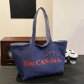 Large canvas tote bag with double straps and mobile phone pocket, 53x35x29cm, available in red, blue, and striped colours.