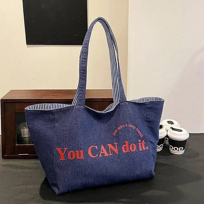 Large canvas tote bag with double straps and mobile phone pocket, 53x35x29cm, available in red, blue, and striped colours.