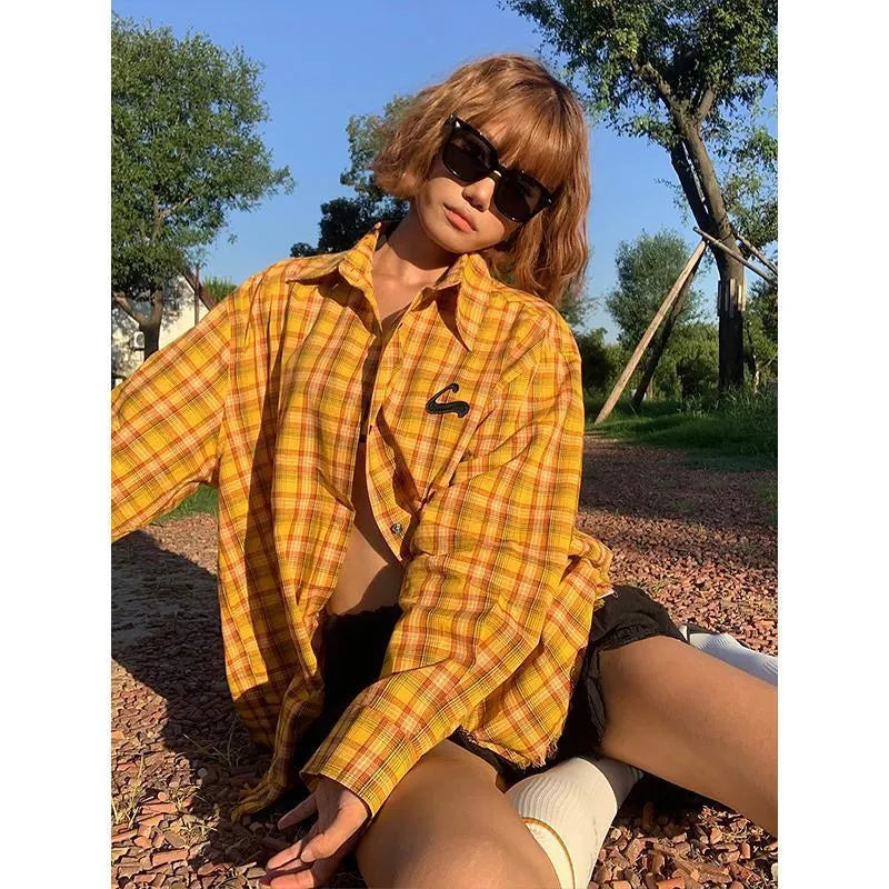 Dopamine yellow and black plaid shirt on a hanger, showing loose fit and cardigan style.