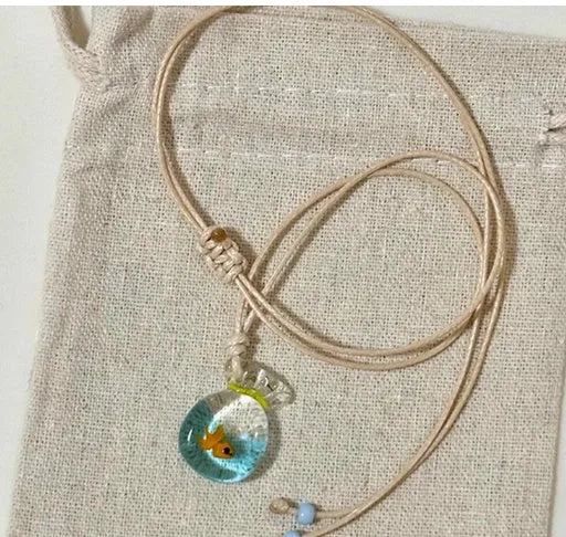 Women's joker pendant necklace with coloured glaze charm on a cotton and linen clavicle chain.