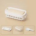 Blue high-capacity ice cube tray with grid design and a built-in storage slot for an ice shovel.