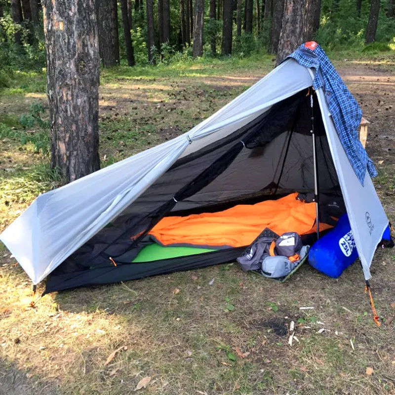 Single-person silicone-coated rodless tent in grey, 205x92x110cm, set up outdoors