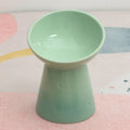 Ceramic pet bowl with a high foot and wide rim for dogs and cats.