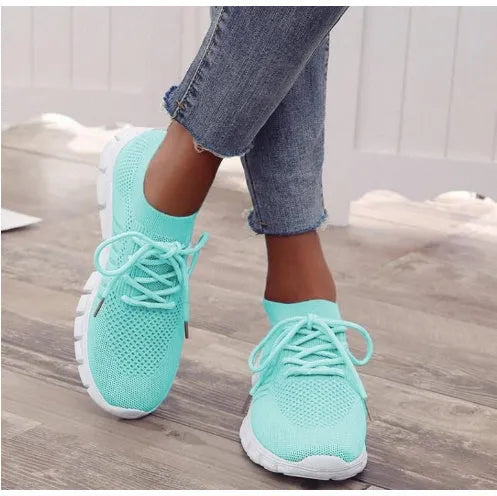 High-cut lace-up platform sneaker in a casual style with a breathable fabric upper and flat rubber sole.