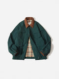 Green and apricot contrast colour casual jacket with side seam pockets on a hanger
