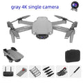 E99Pro2 folding dual camera drone black with propellers on table