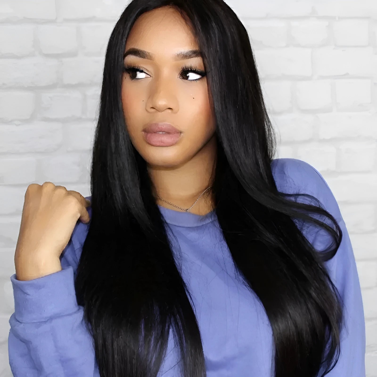 Long black straight synthetic wig with a centre-parted fringe on a mannequin head.