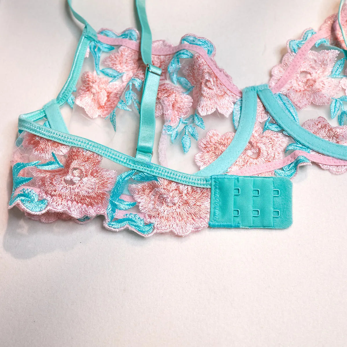 Pink women's mesh pettiskirt bikini set with embroidery detail on polyester fabric.