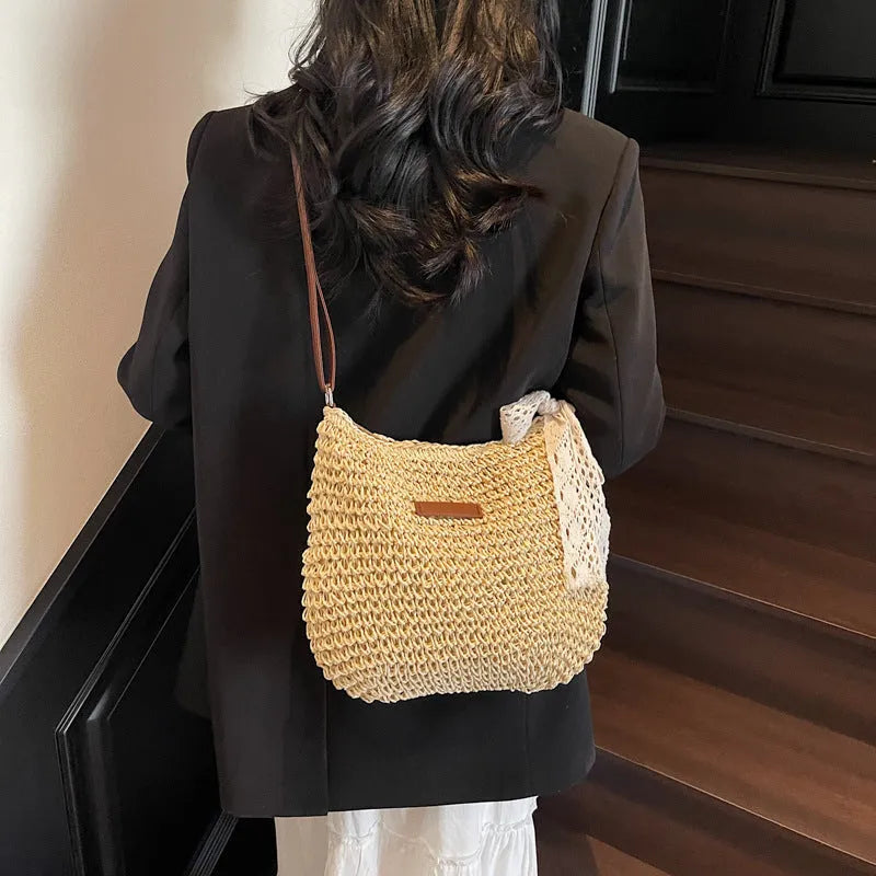 Women's woven straw shoulder messenger bag in khaki with zip pocket and single strap.