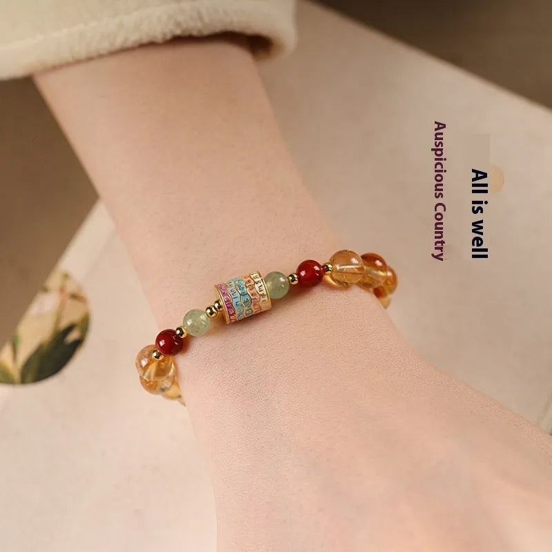 Yellow citrine bracelet with prayer wheel elements on 8mm round beads