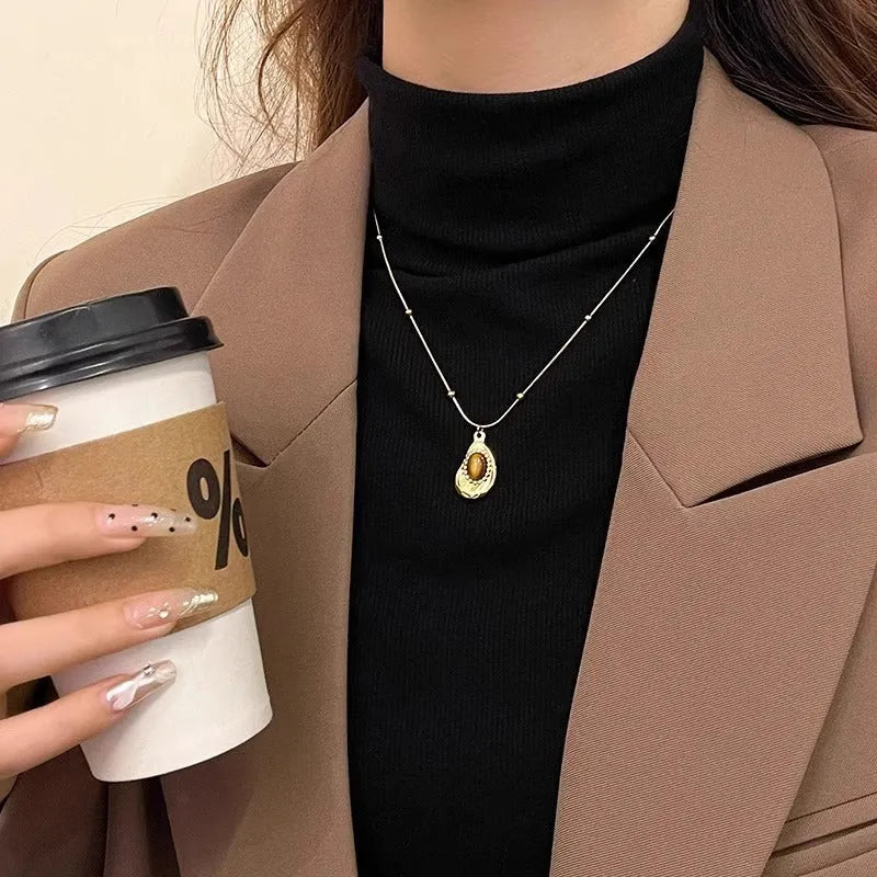 Gold titanium steel clavicle necklace with irregular amber tiger eye stone pendant