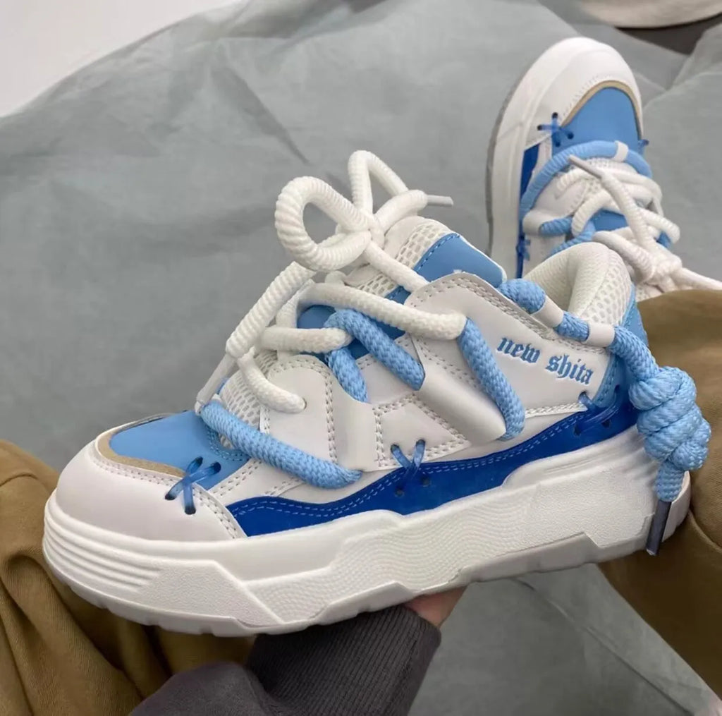 Women's grey retro chunky sneakers with thick rubber platform sole and front lace-up closure