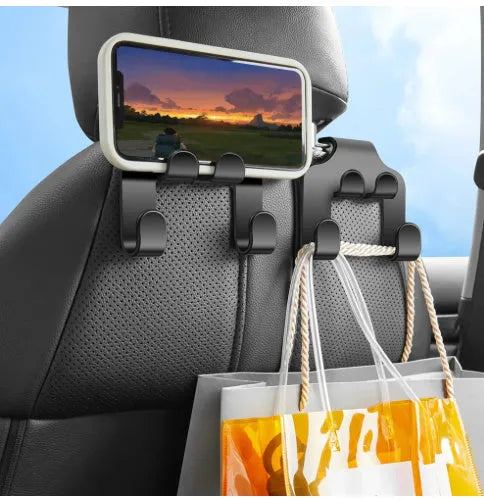 Two white ABS plastic car hooks for mounting phones and organising items in vehicles.