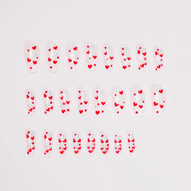 Red diamond and small cherry pattern nail art stickers on a sheet, with a tube of glue.