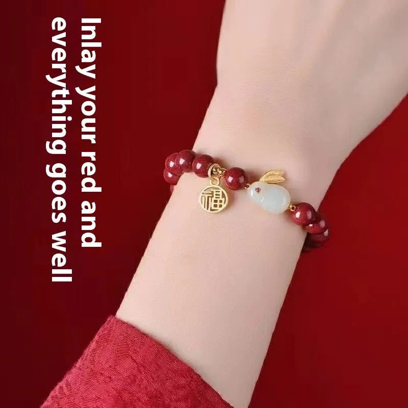 Purple gold sand cinnabar bracelet with jade hare charm in 6mm and 8mm bead sizes.