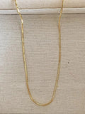 Women's geometric alloy pendant necklace with polished finish and gold copper clavicle chain on neutral background