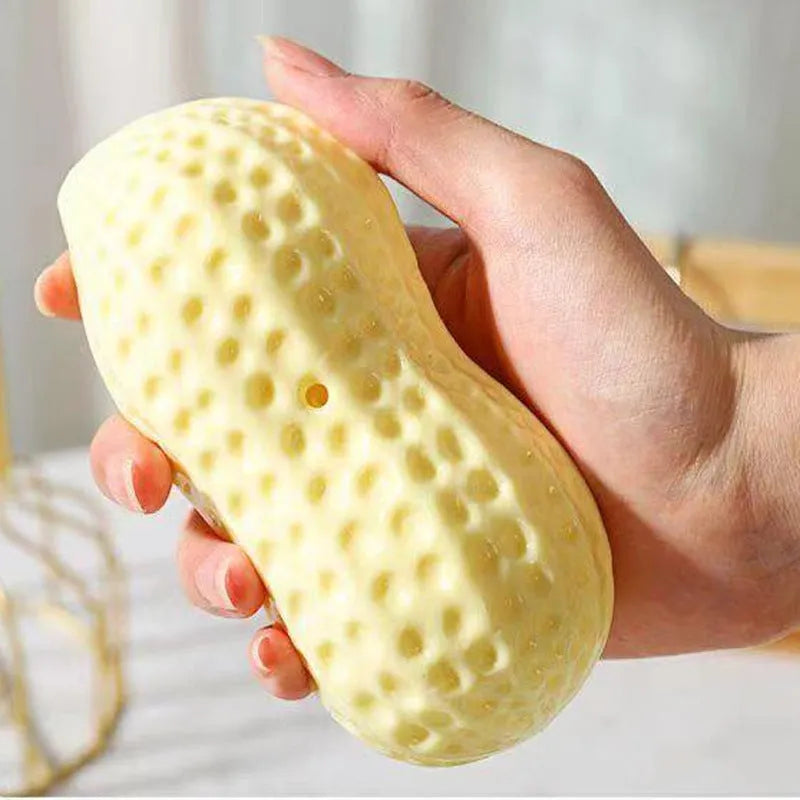 Yellow peanut-shaped dog chew toy with textured shell for teeth cleaning