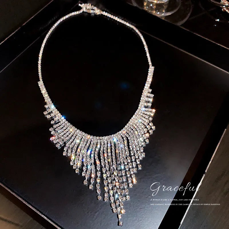 Silver alloy diamond tassel necklace with geometric pendant and ball bead chain on a woman