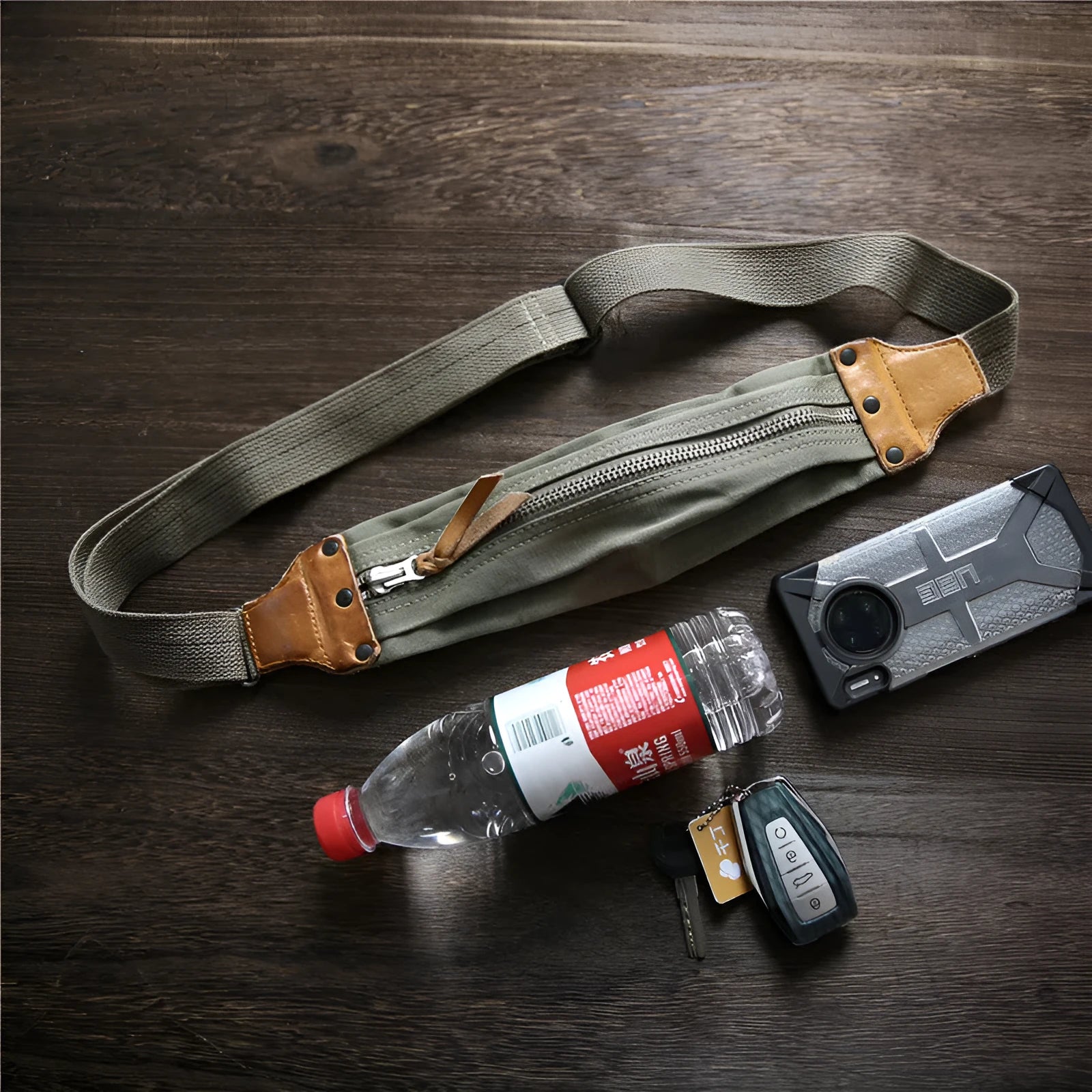 Green retro military style chest bag made of canvas with leather accents.