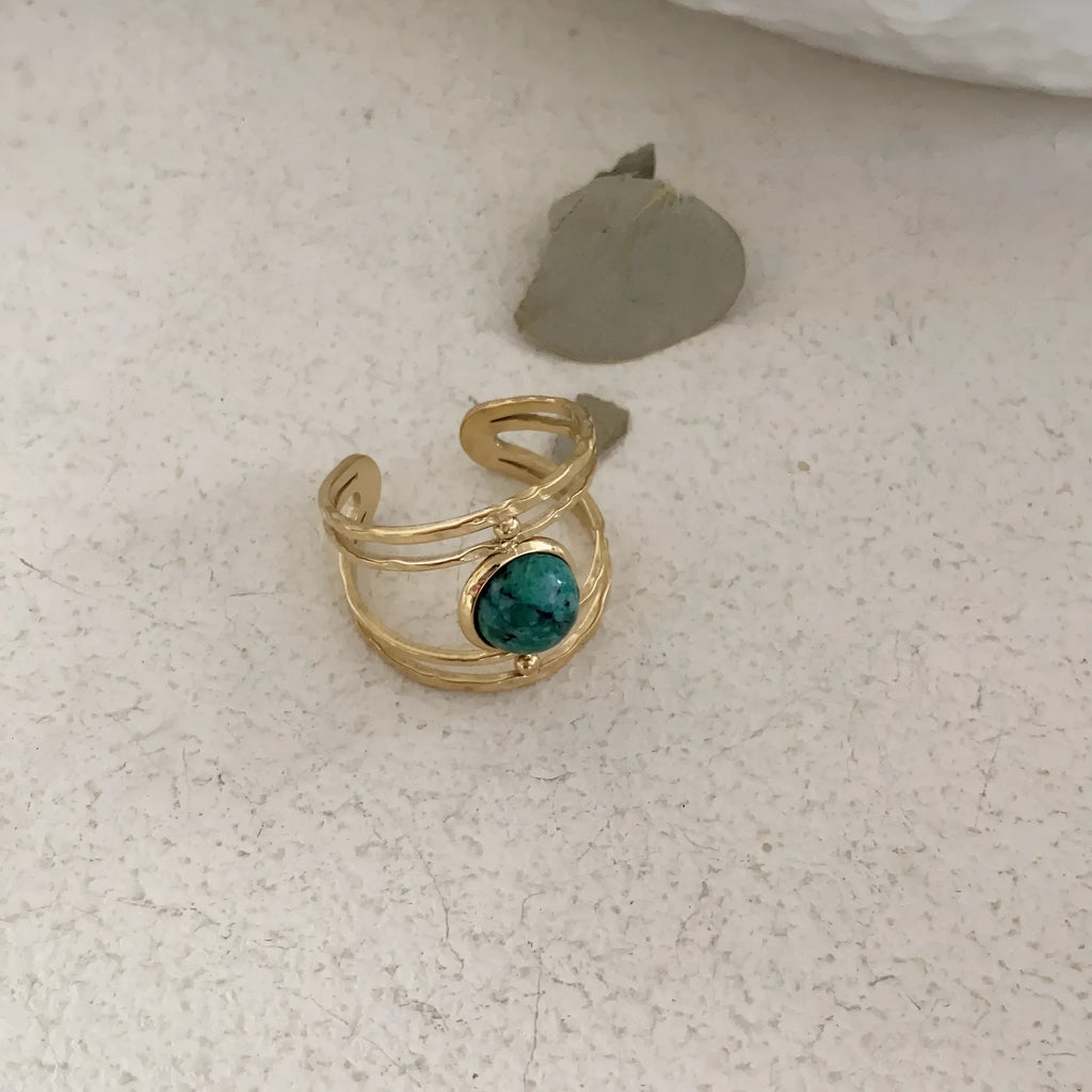 Geometric open ring made of titanium steel with a green natural stone.