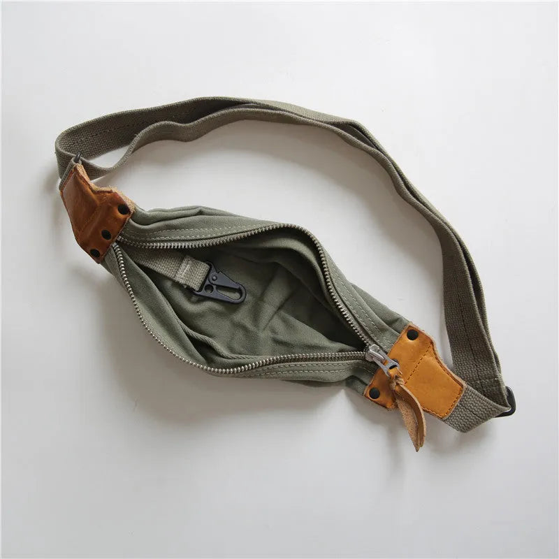 Green retro military style chest bag made of canvas with leather accents.